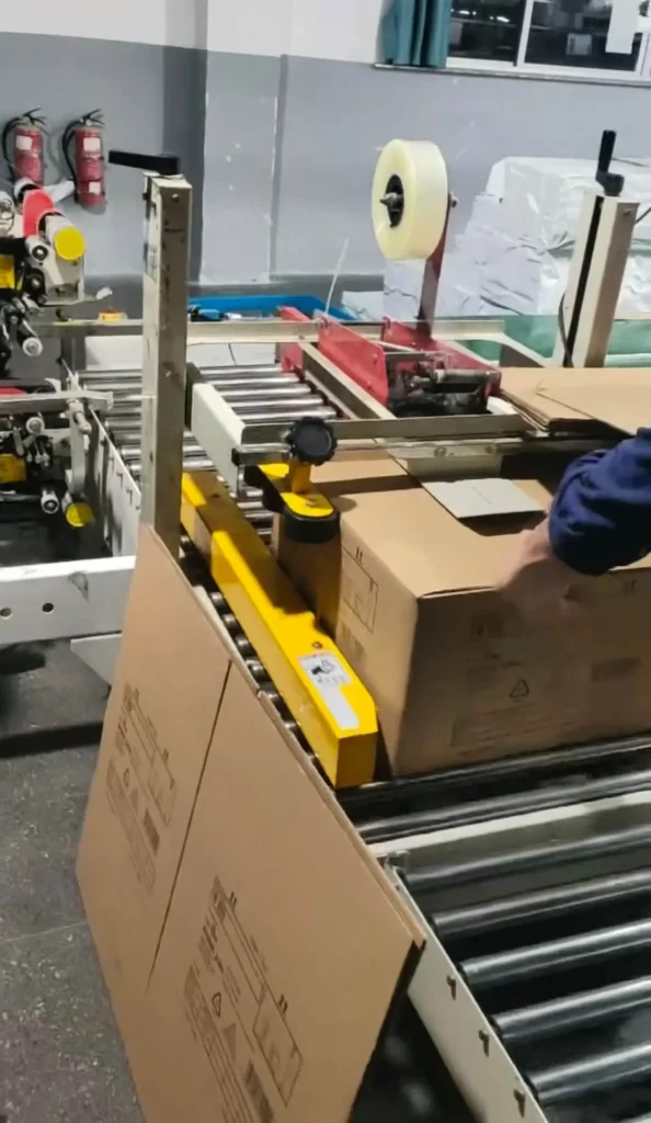 Packaging process at a hand blender manufacturer, preparing immersion blenders for export.