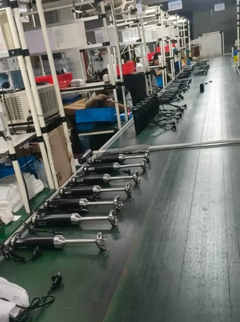 Packaging process at a hand blender manufacturer, preparing immersion blenders for export.